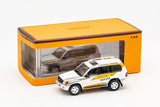 1:64 Toyota Land Cruiser 100 19971 -- Toyota White/Gold/Grey -- GCD